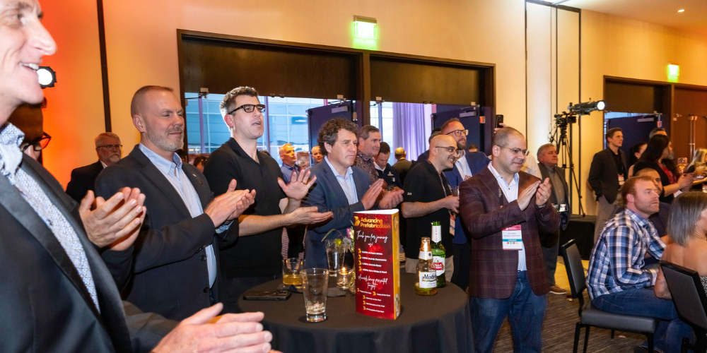 Picture of attendees applauding the winner of an award